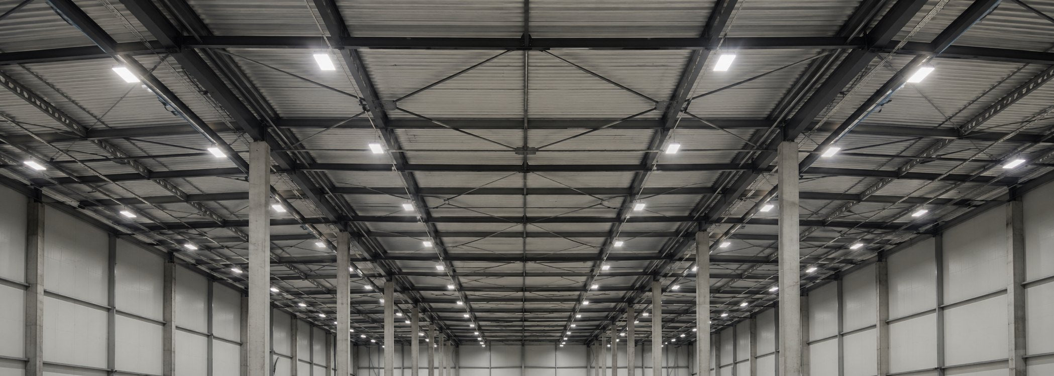 Warehouse ceiling with rows of linear LED high bay fixtures